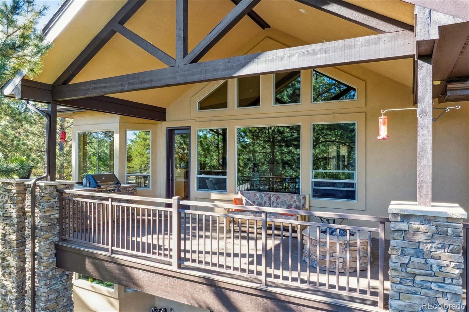 7994 Monarch Road Larkspur, CO 80118 - Photo 40 of 48 a view of a house with porch and wooden floor