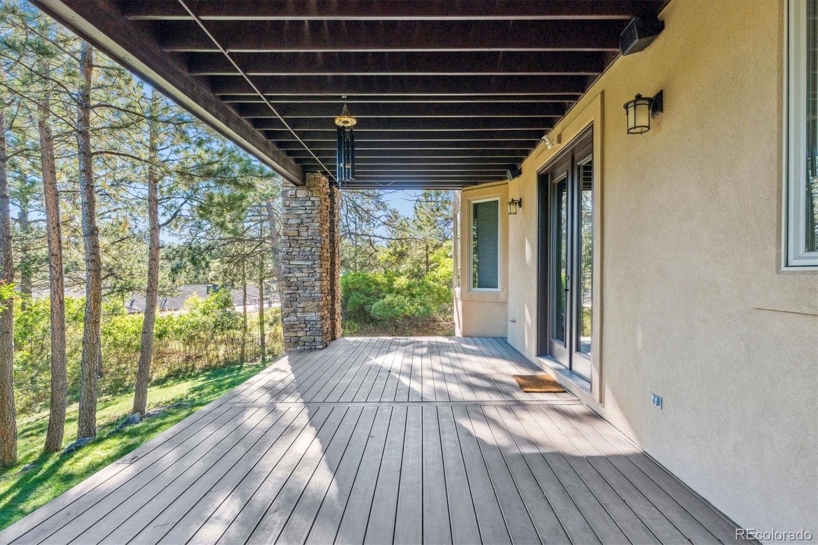 7994 Monarch Road Larkspur, CO 80118 - Photo 41 of 48 a view of porch with wooden floor and outdoor space