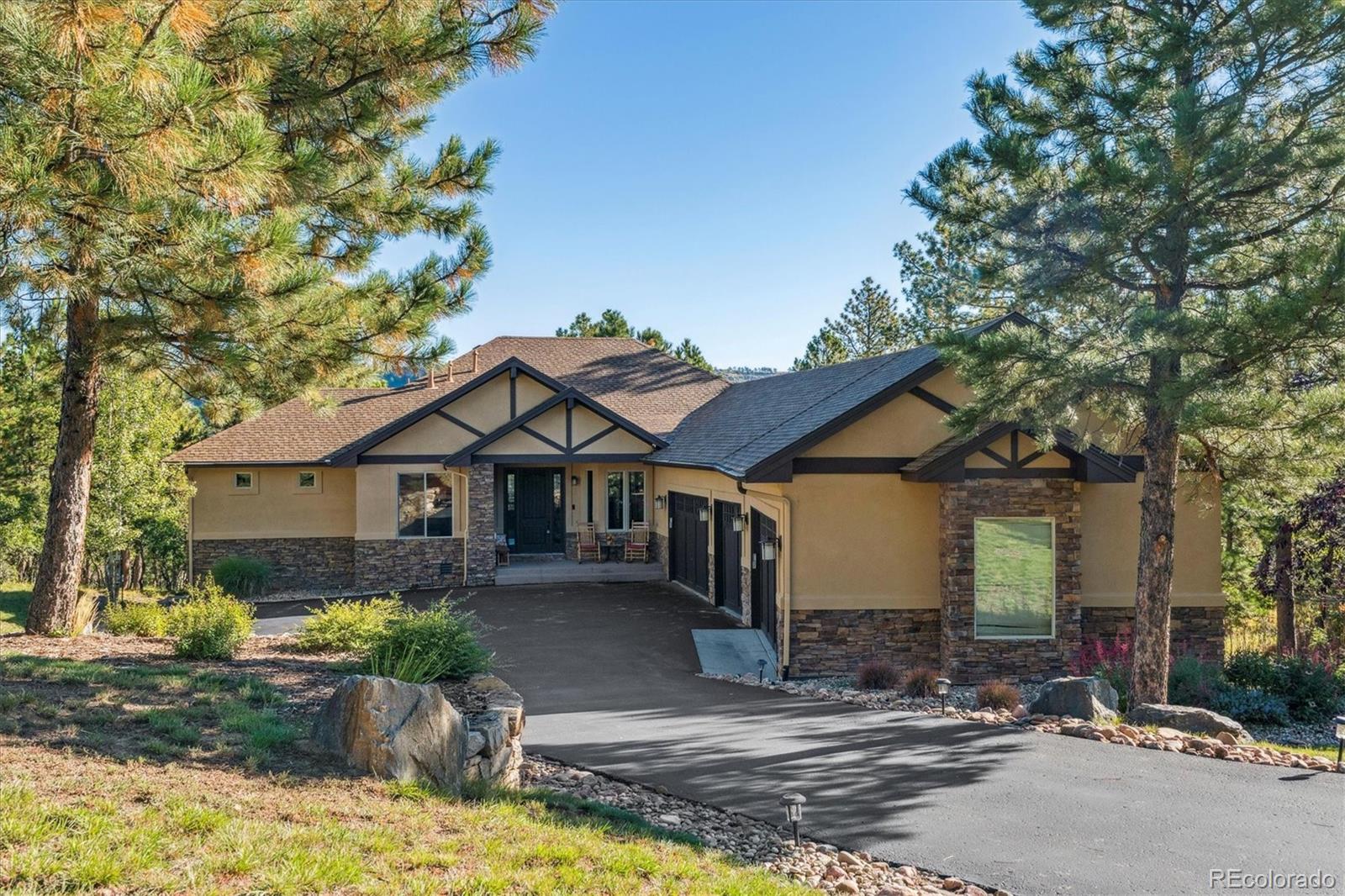 7994 Monarch Road Larkspur, CO 80118 - Photo 48 of 48 a view of a house with a small yard plants and large tree