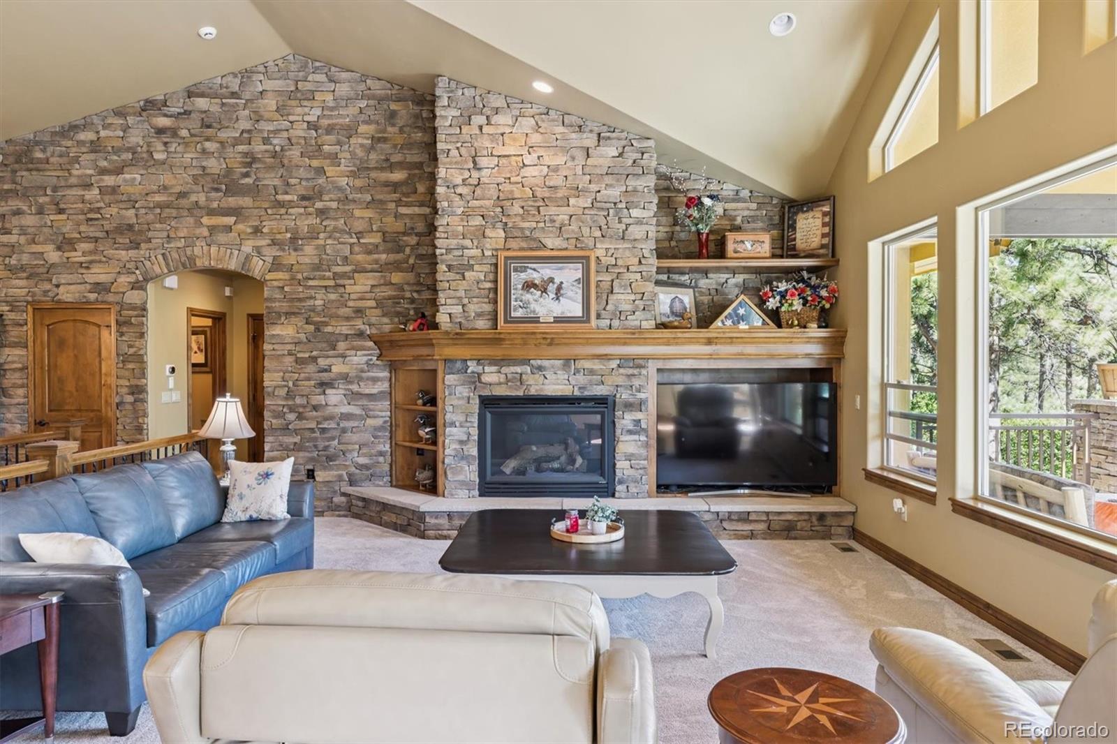7994 Monarch Road Larkspur, CO 80118 - Photo 5 of 48 a living room with furniture and a fireplace