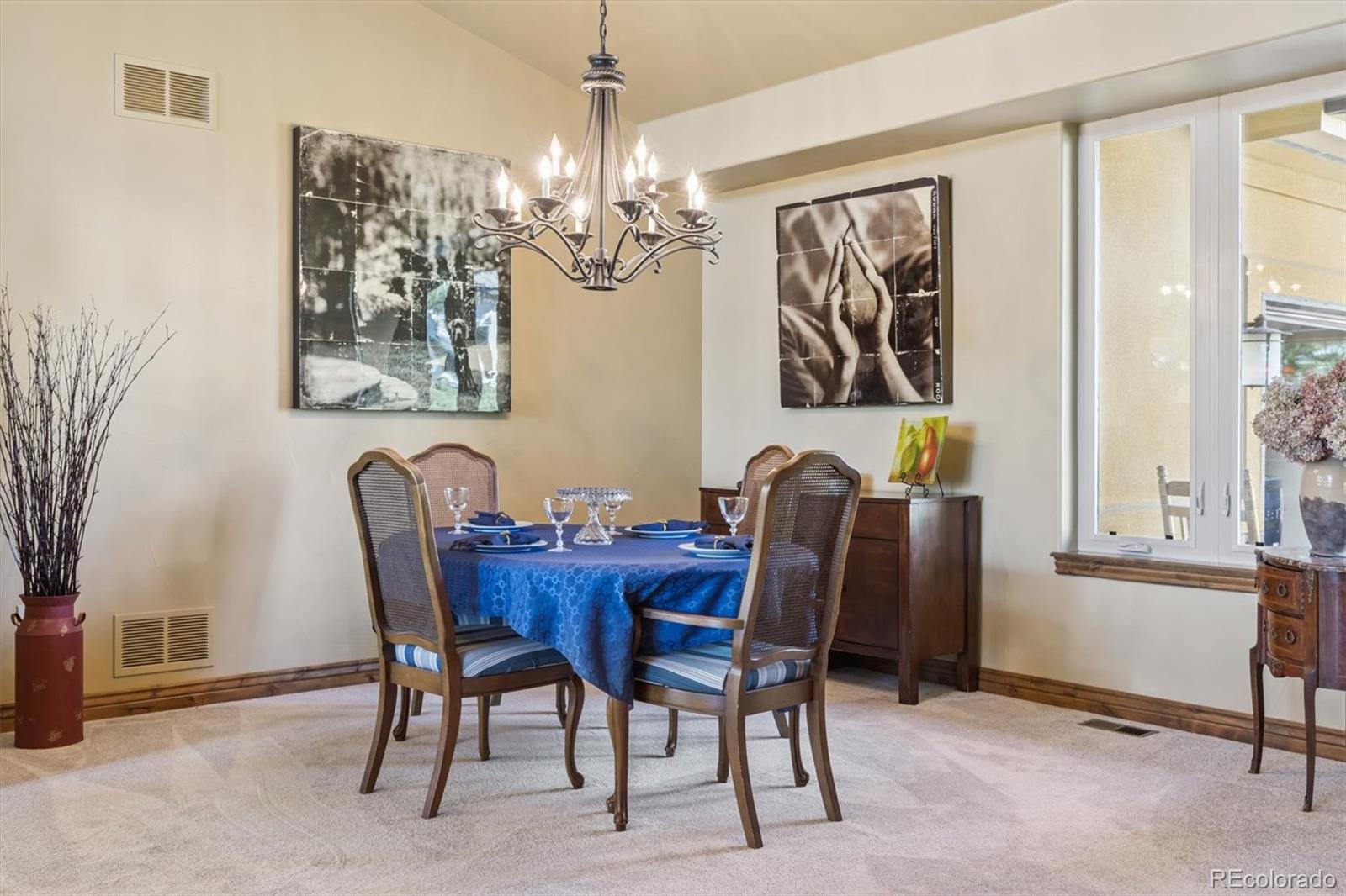 7994 Monarch Road Larkspur, CO 80118 - Photo 6 of 48 a view of a dining room with furniture and chandelier