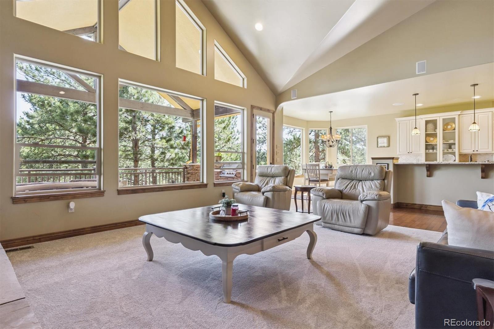 7994 Monarch Road Larkspur, CO 80118 - Photo 7 of 48 a living room with furniture and floor to ceiling windows