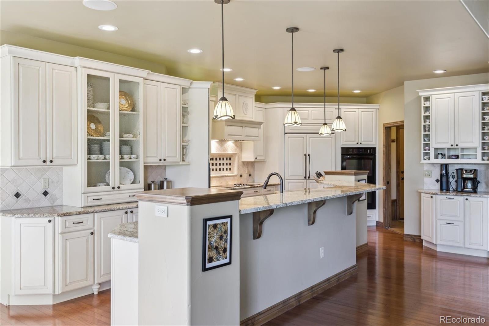 7994 Monarch Road Larkspur, CO 80118 - Photo 8 of 48 a kitchen with stainless steel appliances granite countertop a sink a stove and a wooden floors