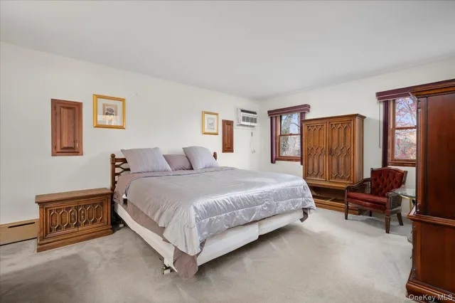 a spacious bedroom with a bed and a dresser in it