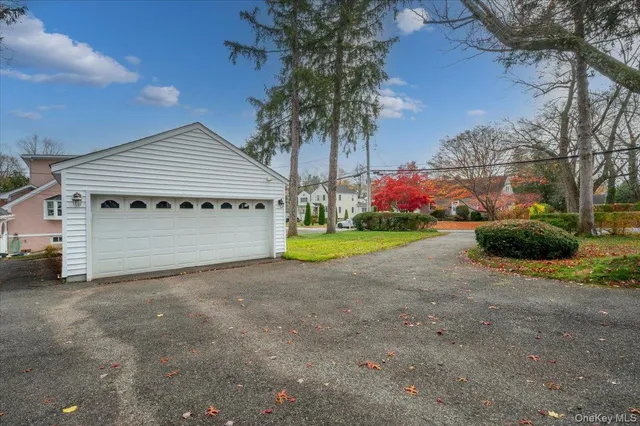 a view of a house with a yard and garage
