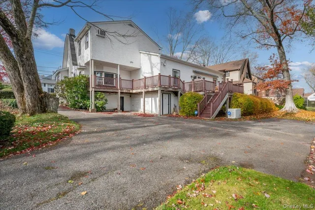 a view of a white house with a street