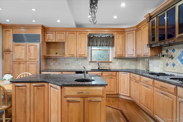 a kitchen with stainless steel appliances granite countertop a sink stove and cabinets