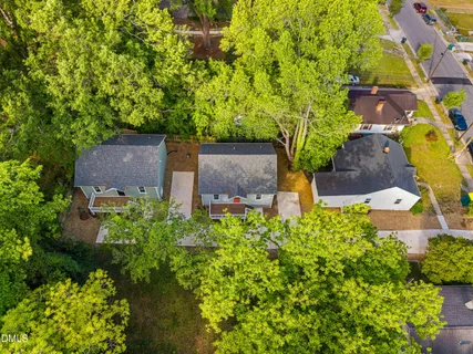 an aerial view of a house with a yard and garden space
