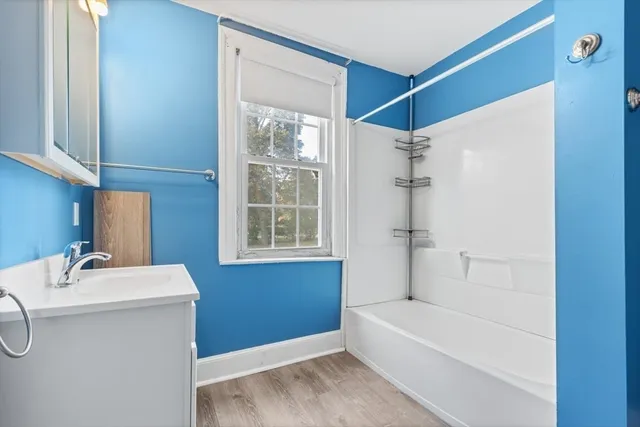 a bathroom with a sink a bathtub and shower