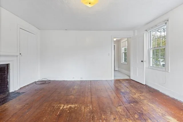 wooden floor in an empty room with a window
