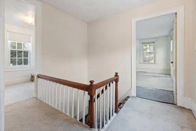 a view of a hallway to a room with stairs
