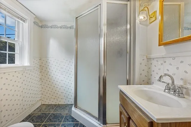 a bathroom with a sink toilet and shower