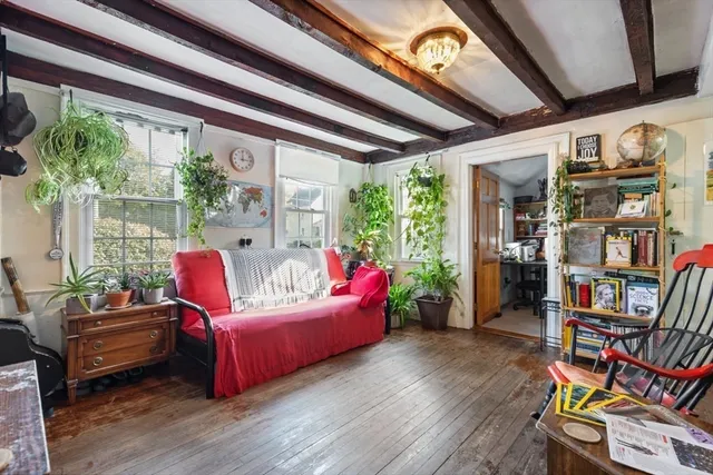 a living room with furniture and a book shelf