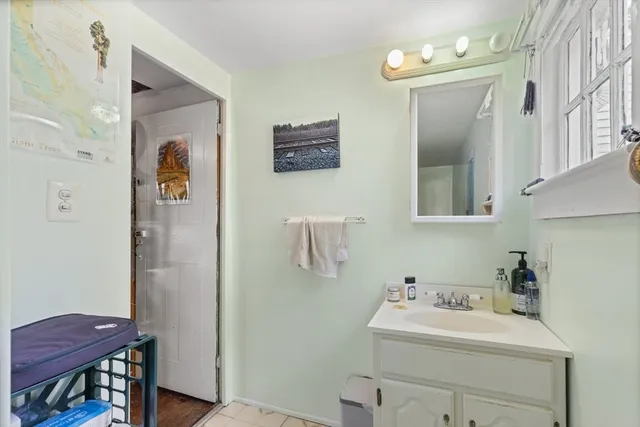 a bathroom with a sink a toilet and mirror