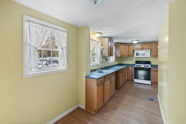 a kitchen with stainless steel appliances granite countertop a stove a sink and a refrigerator