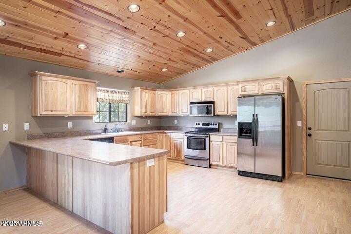3244 Outlaw Trail Overgaard, AZ 85933 - Photo 11 of 29 a kitchen with stainless steel appliances granite countertop a sink a stove and refrigerator