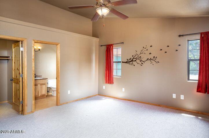 3244 Outlaw Trail Overgaard, AZ 85933 - Photo 15 of 29 en empty room with windows and ceiling fan