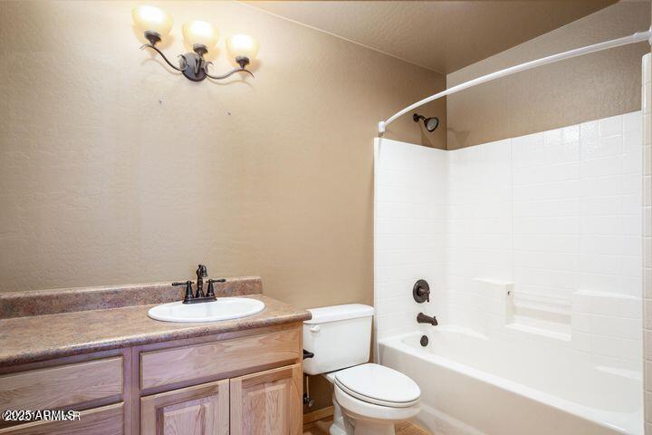 3244 Outlaw Trail Overgaard, AZ 85933 - Photo 17 of 29 a bathroom with a sink a toilet and shower