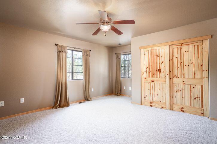 3244 Outlaw Trail Overgaard, AZ 85933 - Photo 19 of 29 an empty room with windows and fan