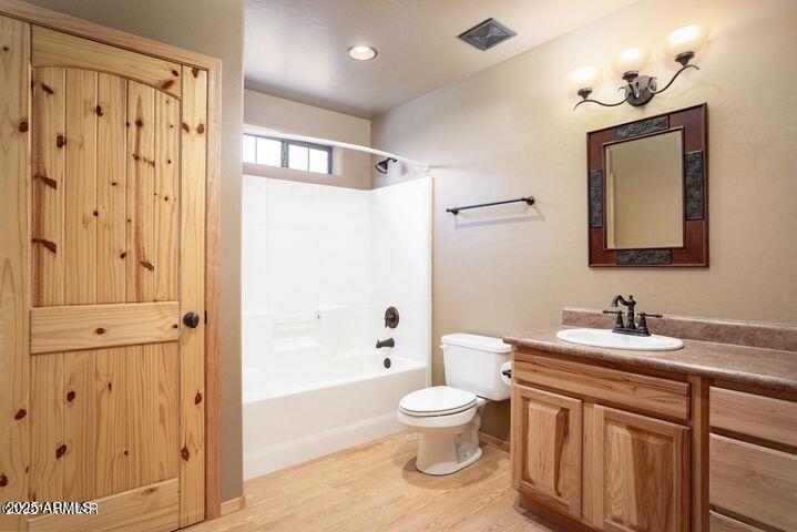 3244 Outlaw Trail Overgaard, AZ 85933 - Photo 20 of 29 a bathroom with a toilet sink shower and mirror