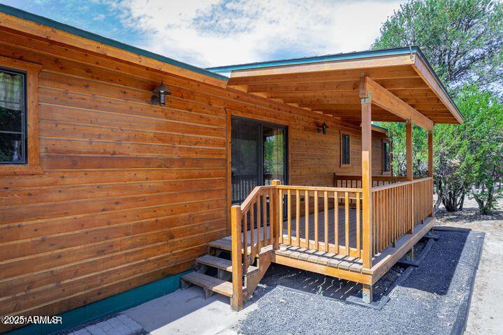 3244 Outlaw Trail Overgaard, AZ 85933 - Photo 5 of 29 a view of a backyard with a deck and wooden floor