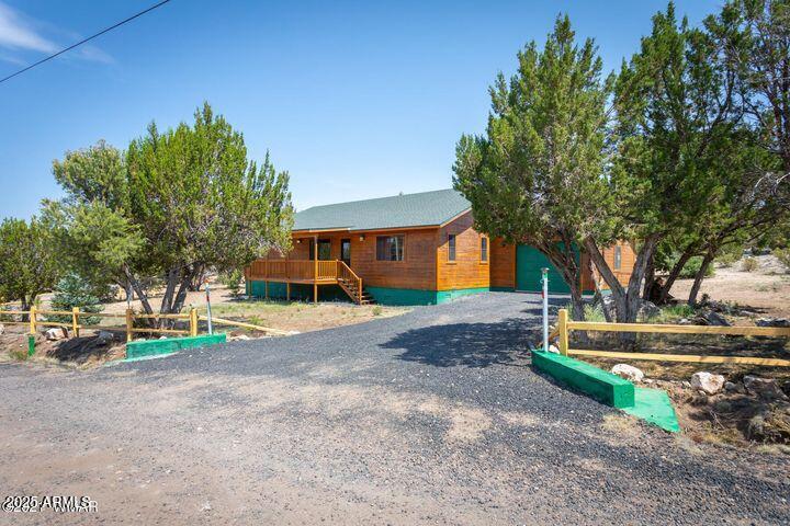 3244 Outlaw Trail Overgaard, AZ 85933 - Photo 6 of 29 a front view of a house with a yard