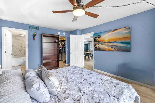 a bedroom with bed and a chandelier