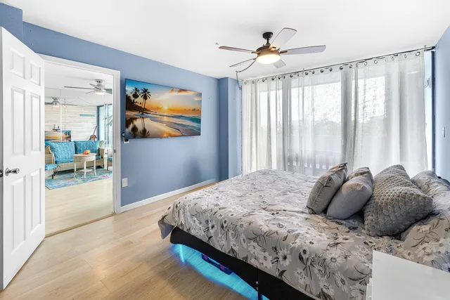 a bedroom with a large bed and a chandelier