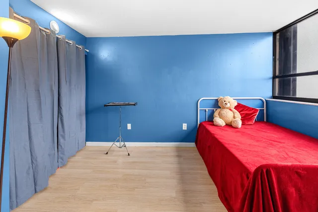 a bedroom with a bed and a lamp