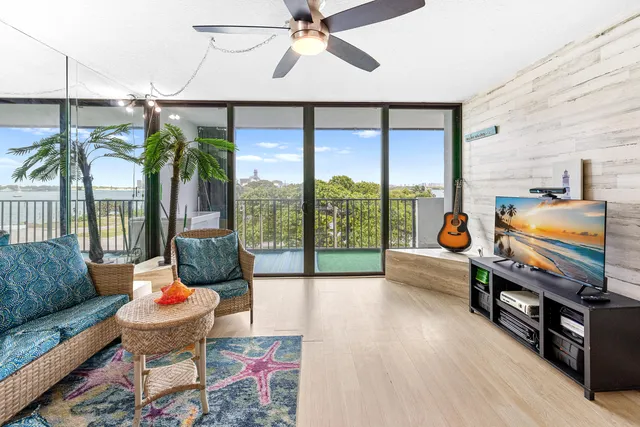 a living room with furniture and a floor to ceiling window