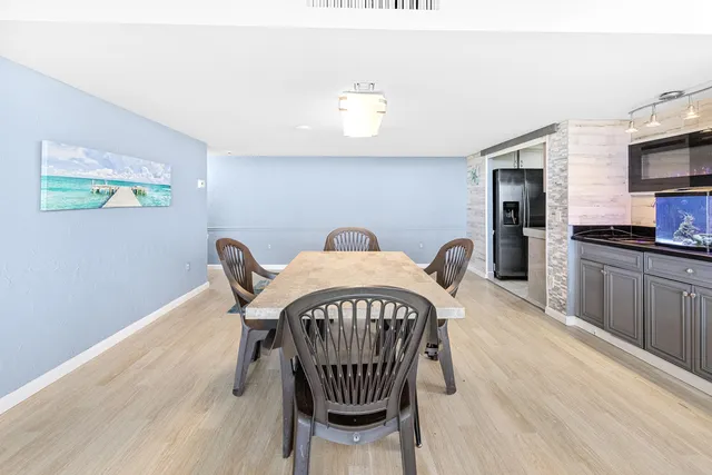 a view of a dining room with furniture a chandelier and wooden floor