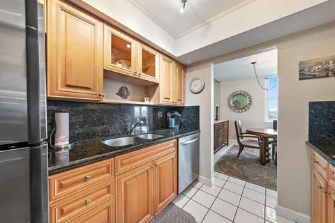 a kitchen with stainless steel appliances granite countertop a stove and a microwave
