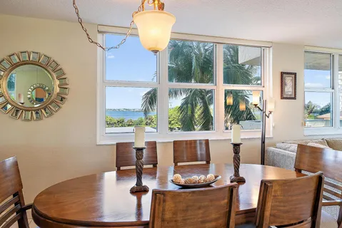 a dining room with furniture a window and wooden floor