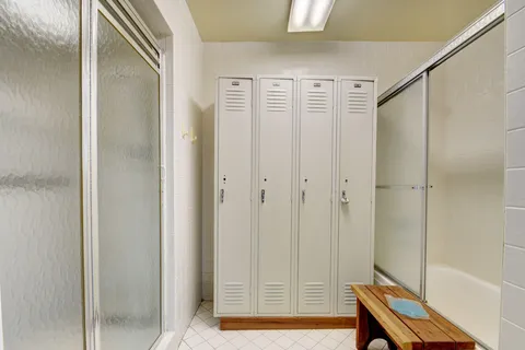 a bathroom with a shower and a mirror