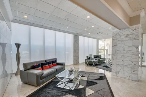 a view of a living room and a balcony
