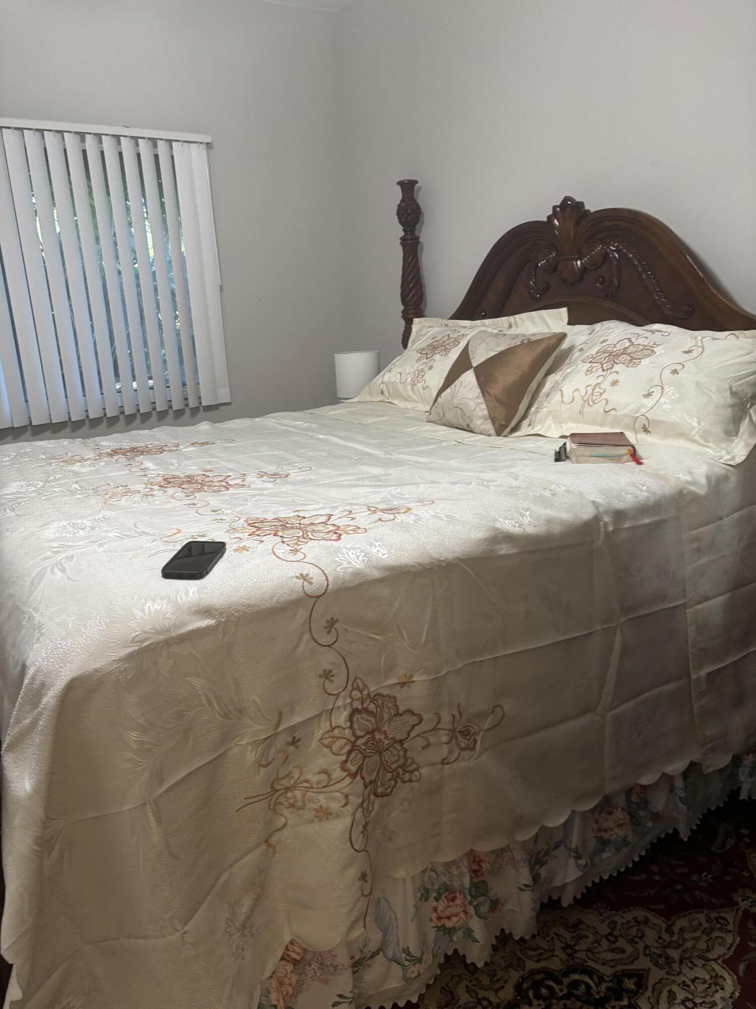 350 Crestwood Circle, Unit 106 Royal Palm Beach, FL 33411 - Photo 17 of 28 a bedroom with a bed