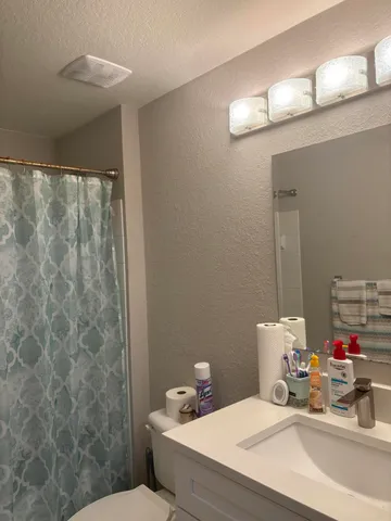 a bathroom with a toilet a sink and a shower