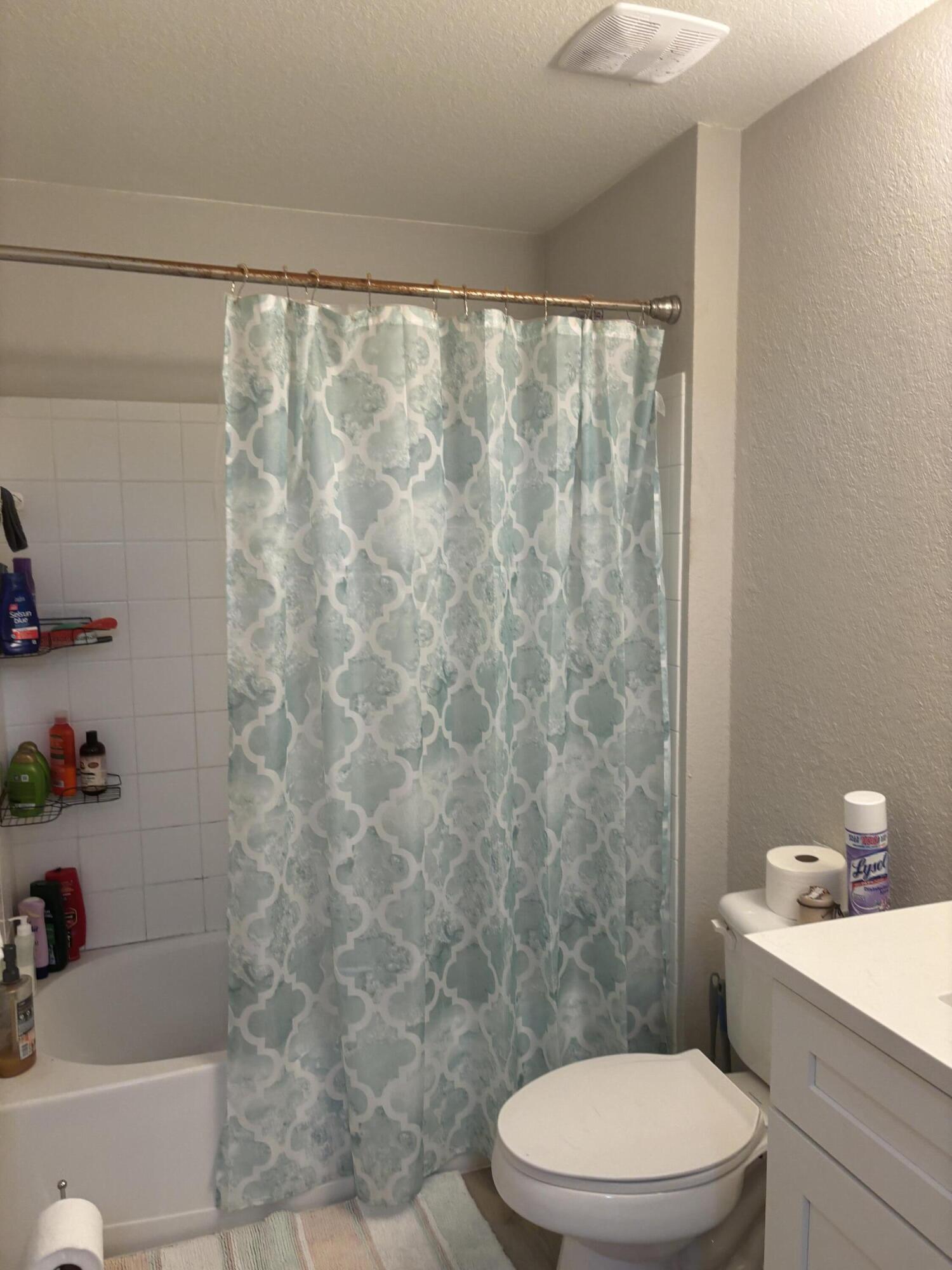 350 Crestwood Circle, Unit 106 Royal Palm Beach, FL 33411 - Photo 20 of 28 a bathroom with a toilet a sink and a shower