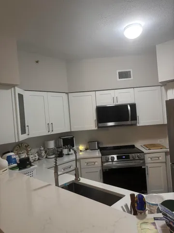 a kitchen with a sink and a stove top oven