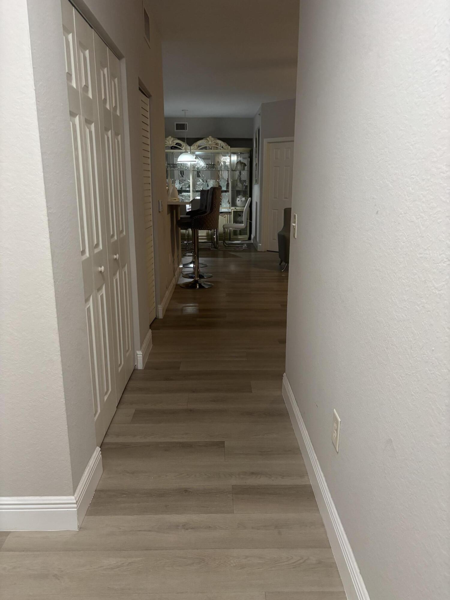 350 Crestwood Circle, Unit 106 Royal Palm Beach, FL 33411 - Photo 22 of 28 a view of entryway and hall with wooden floor