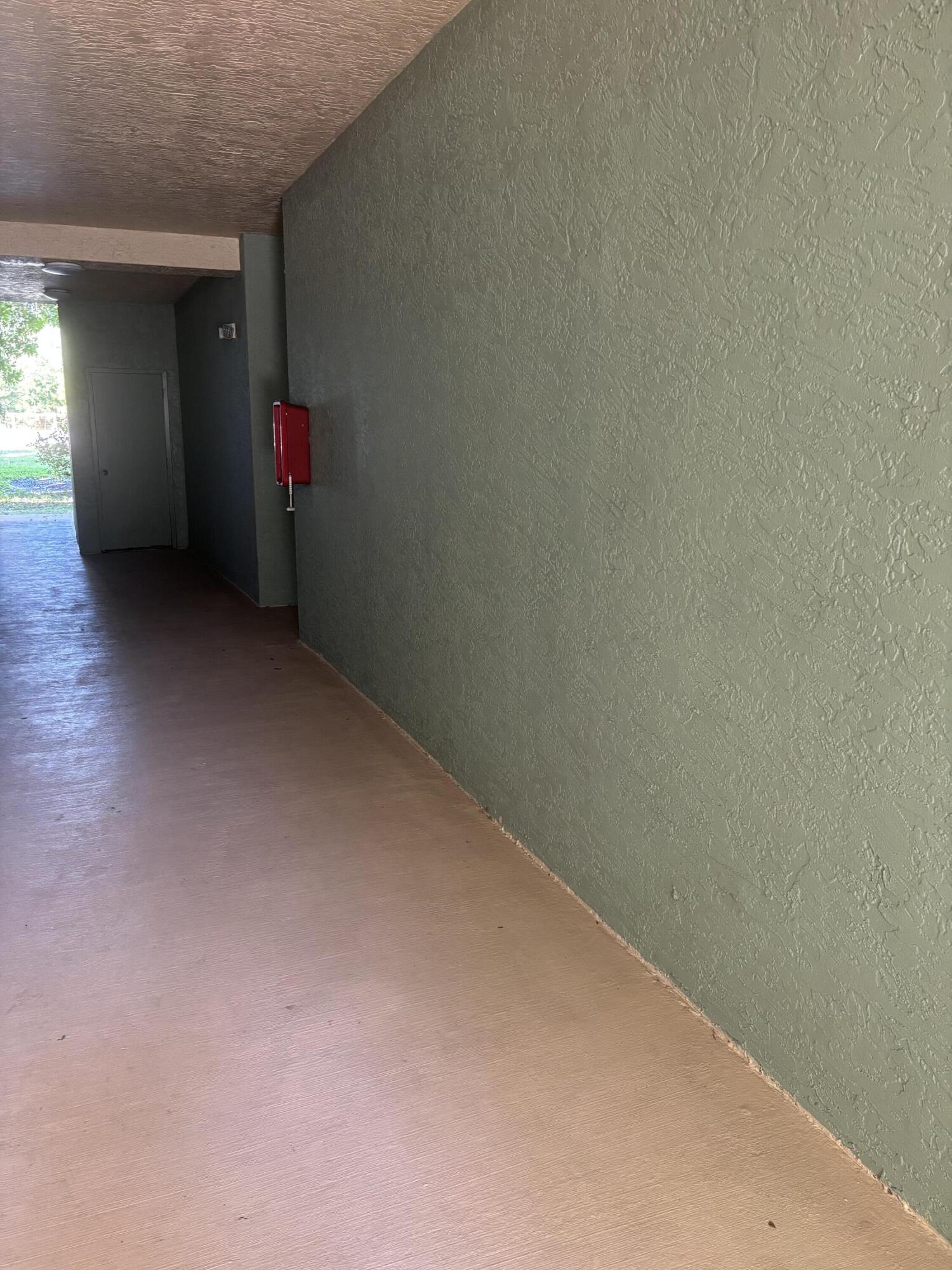 350 Crestwood Circle, Unit 106 Royal Palm Beach, FL 33411 - Photo 23 of 28 an empty room with wooden floor and windows