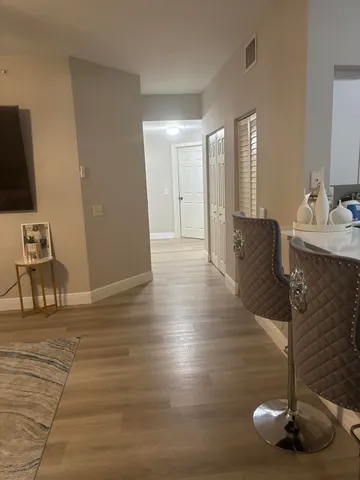 a view of a living room and dining room with wooden floor