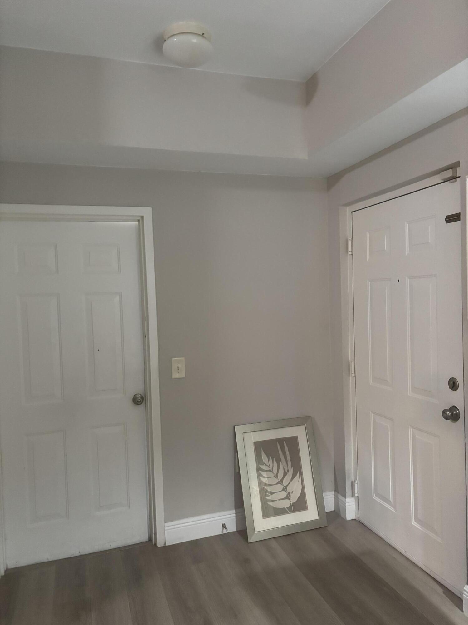 350 Crestwood Circle, Unit 106 Royal Palm Beach, FL 33411 - Photo 4 of 28 a view of an empty room with window and hardwood floor