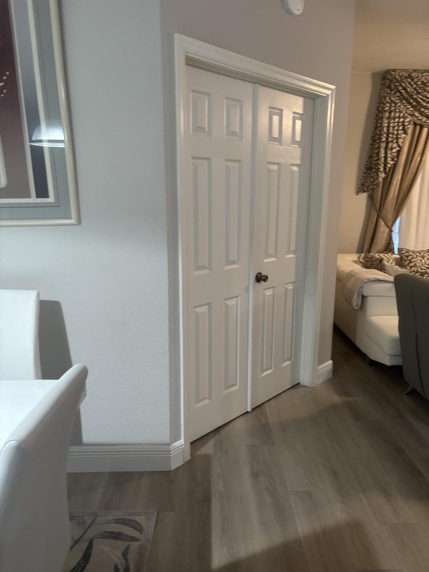 350 Crestwood Circle, Unit 106 Royal Palm Beach, FL 33411 - Photo 5 of 28 a view of a room with furniture and a window