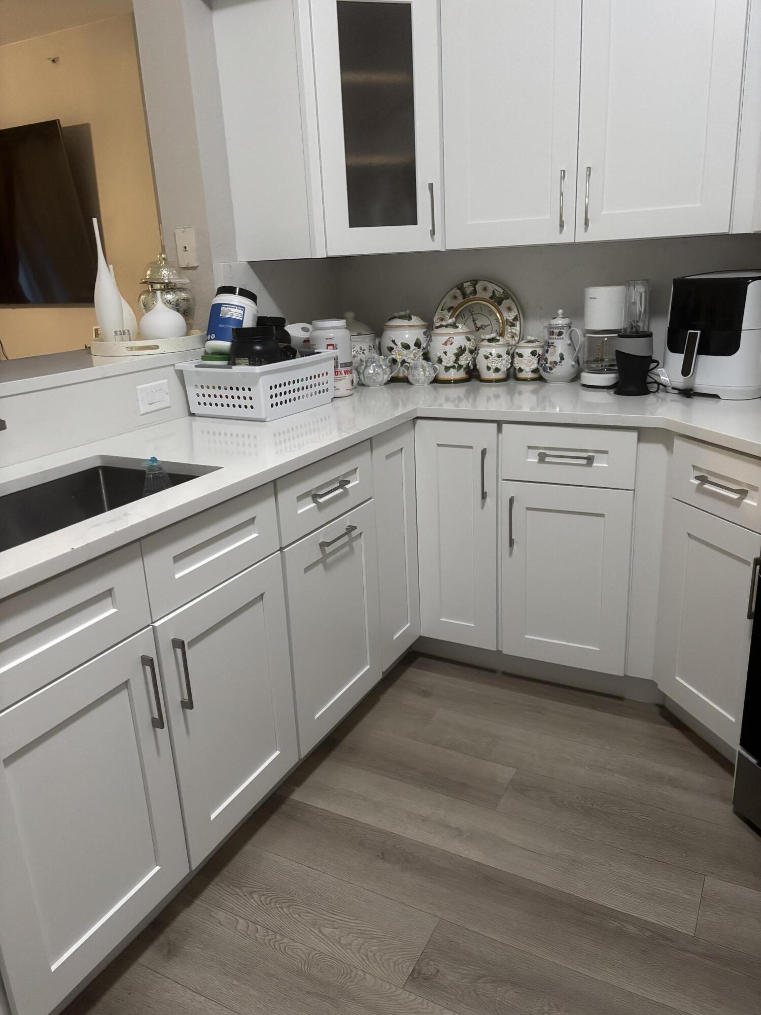 350 Crestwood Circle, Unit 106 Royal Palm Beach, FL 33411 - Photo 6 of 28 a kitchen with a sink and cabinets