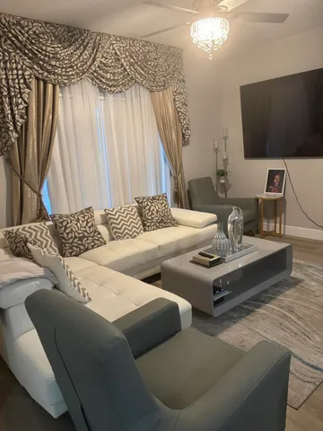 a living room with couches and a flat screen tv