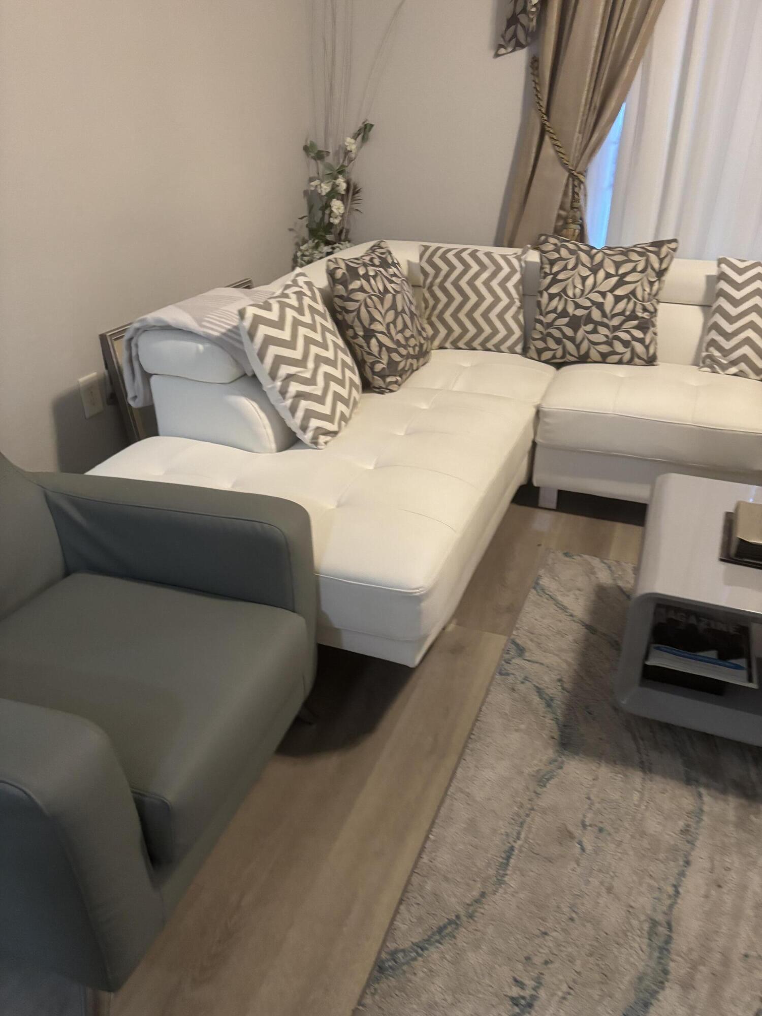 350 Crestwood Circle, Unit 106 Royal Palm Beach, FL 33411 - Photo 10 of 28 a bedroom with a bed and a couch