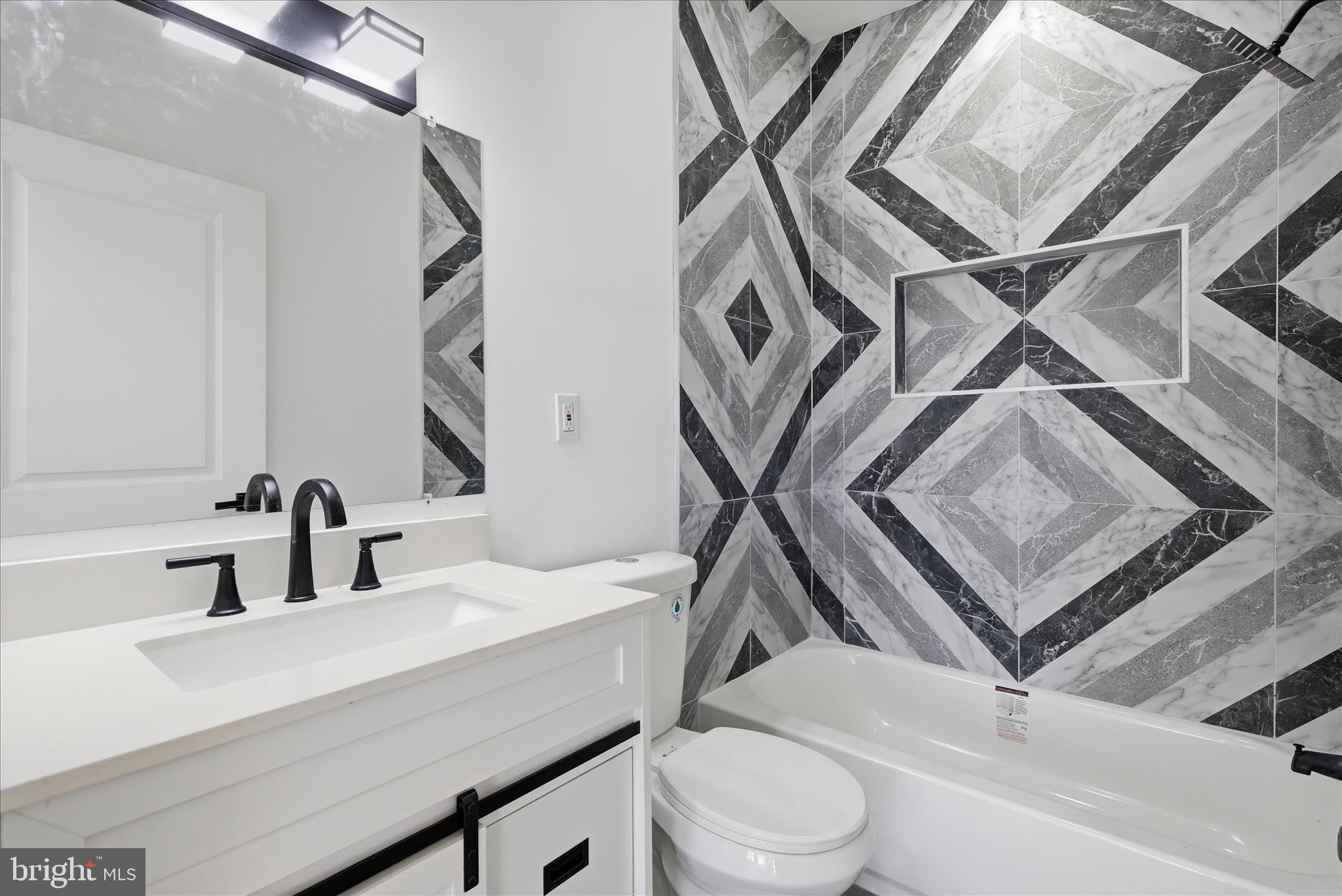 4668 Pimlico Road Baltimore, MD 21215 - Photo 13 of 32 a bathroom with a sink a toilet and a mirror