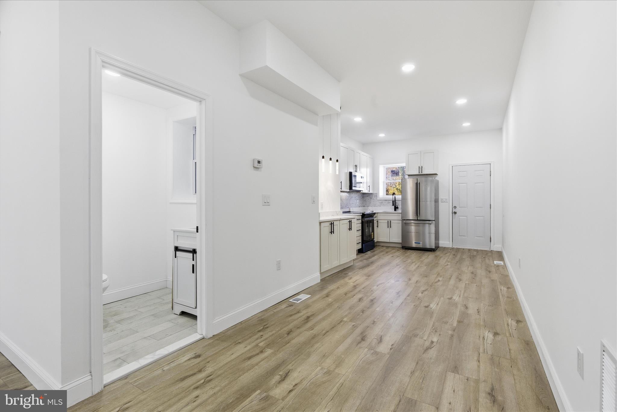 4668 Pimlico Road Baltimore, MD 21215 - Photo 5 of 32 a view of a kitchen with a sink and refrigerator
