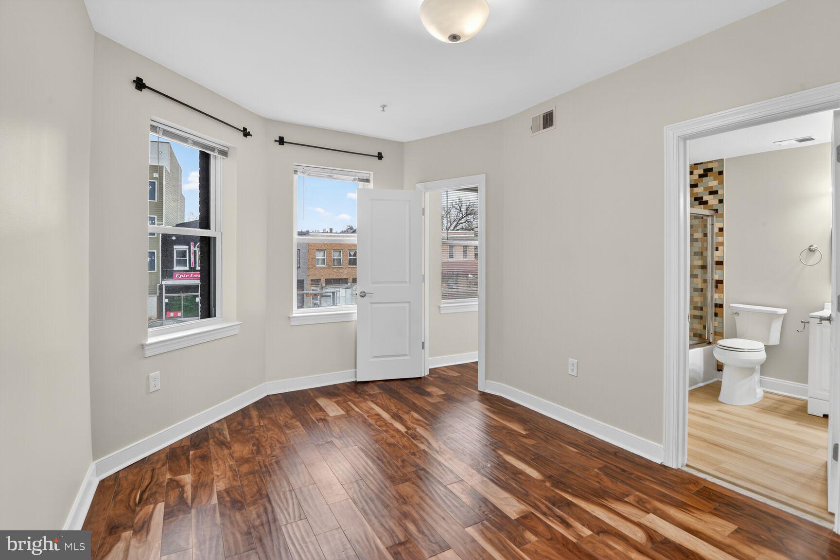 4800 Georgia Avenue Northwest, Unit 205 Washington, DC 20011 - Photo 11 of 15 a view of a room with wooden floor and a ceiling fan